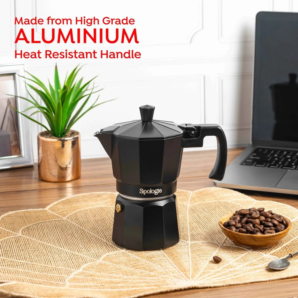 A black aluminium moka pot with a heat resistant handle sits on a woven placemat on a wooden table, with a bowl of coffee beans, a small plant, and a laptop in the background. Text on the image reads 'Made from High Grade ALUMINIUM Heat Resistant Handle' and the brand 'Sipologie' is visible on the pot.