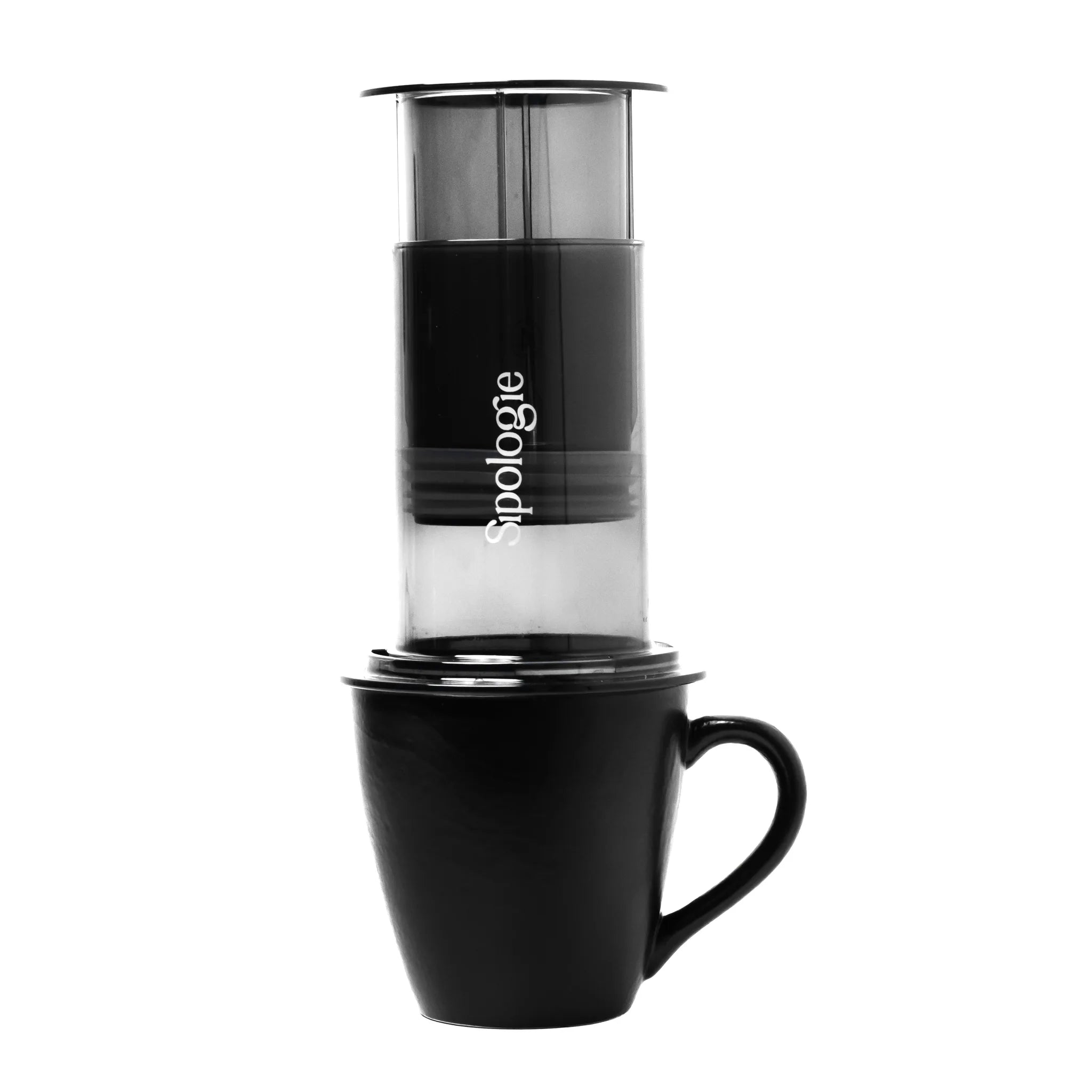 A black coffee maker with a clear upper chamber and white 'Sipologie' branding, shown on a white background with a black mug underneath.