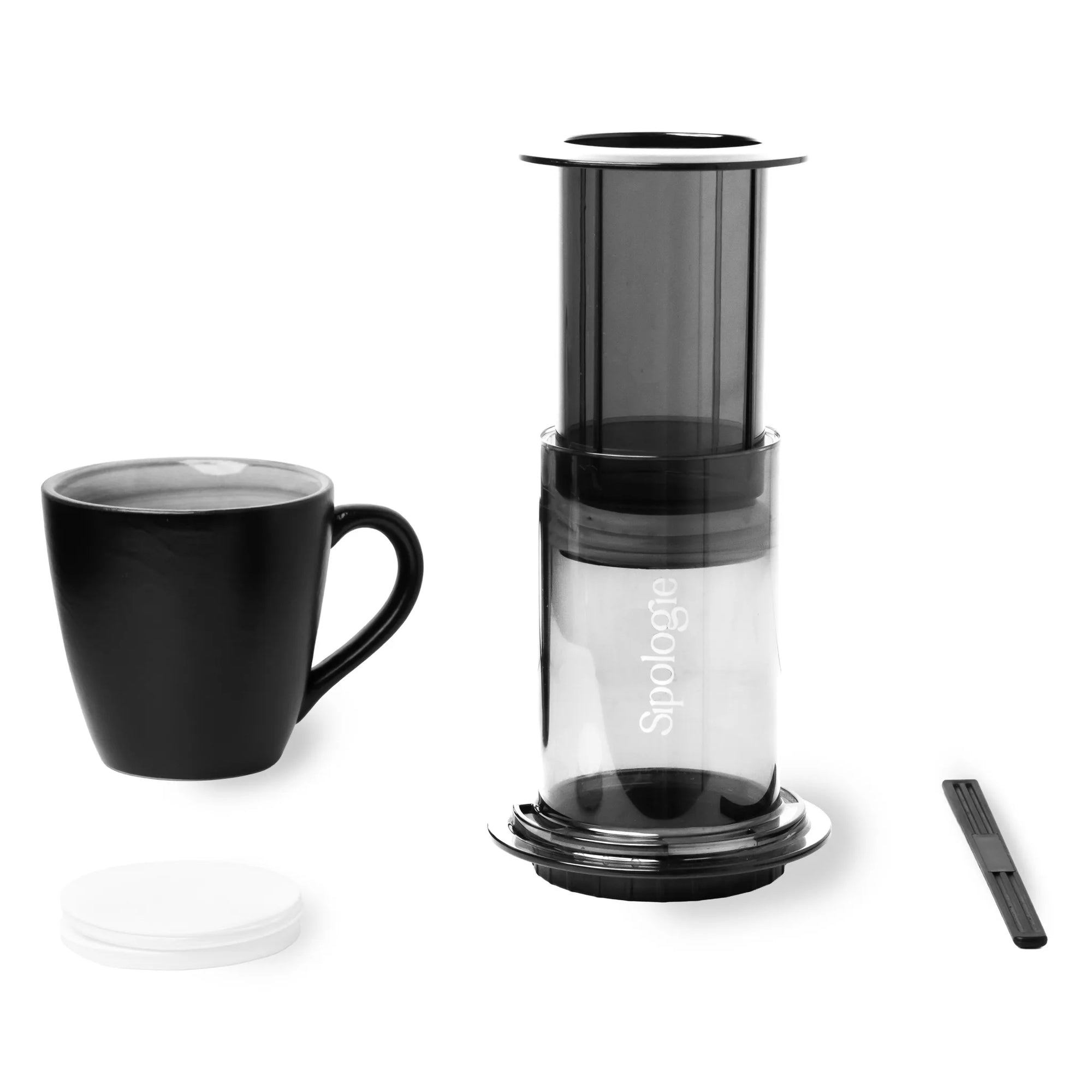 Black AeroPress coffee maker with a black mug on a white background