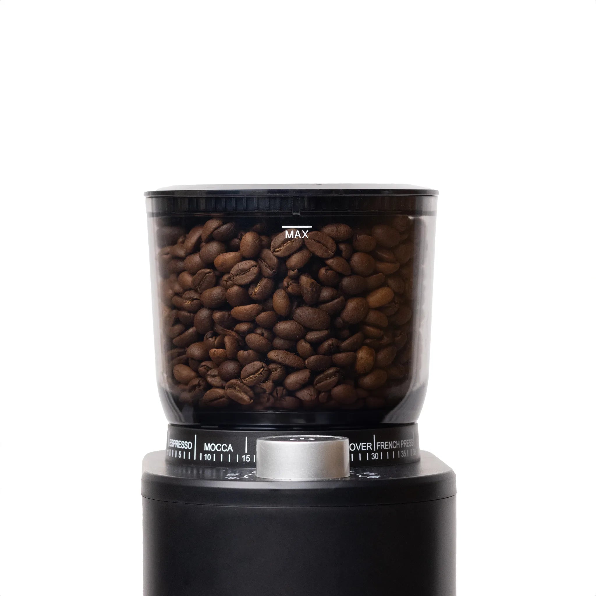 A close-up of a black coffee grinder filled with roasted brown coffee beans, shown against a plain white background.