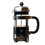 A Sipologie French press coffee maker with a clear glass body, black handle, black plastic filter basket, and stainless steel lid and frame. The glass is partially filled with dark coffee, and the product is photographed against a solid white background.