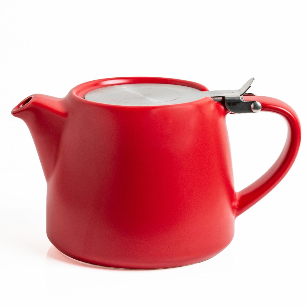 Red ceramic teapot in a white background