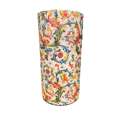 A cylindrical container or vase with a lid, decorated with a vibrant, multicolored baroque-style floral and scroll pattern on a textured cream background, isolated on a white background.