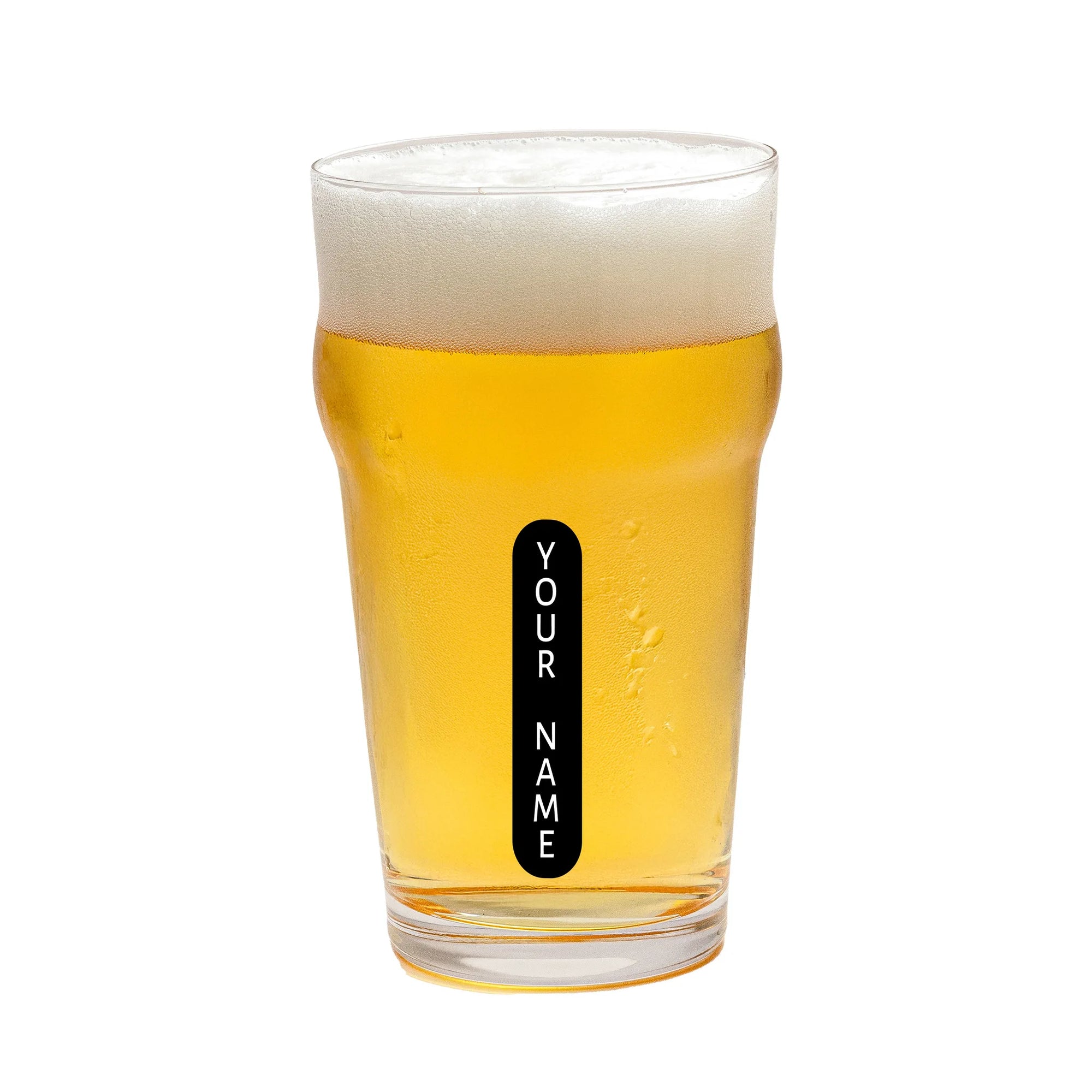 A clear pint glass filled with golden beer and topped with white foam, featuring a vertical black label that reads 'YOUR NAME' in white text, isolated on a white background.