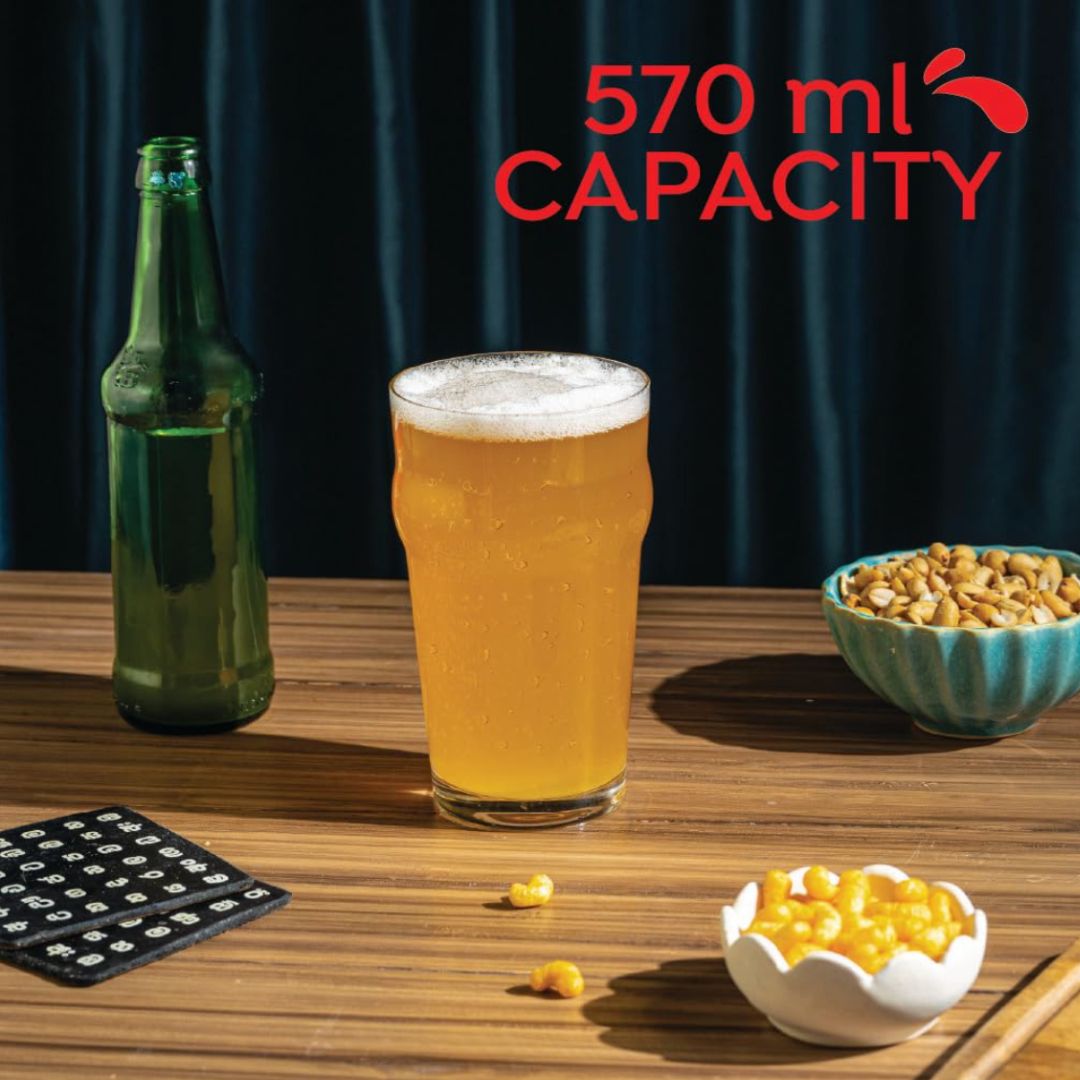 Glass of beer with a bottle, snacks, and '570 ml Capacity' text on a wooden table.