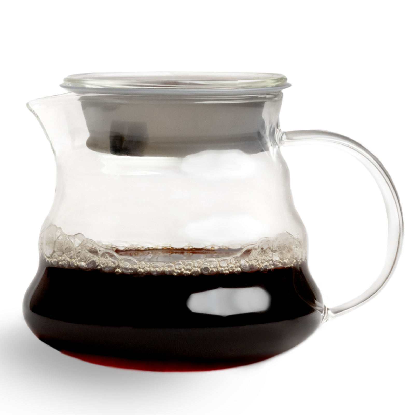 A transparent glass coffee server with a handle, partially filled with freshly brewed black coffee and light foam, sitting on a white background.